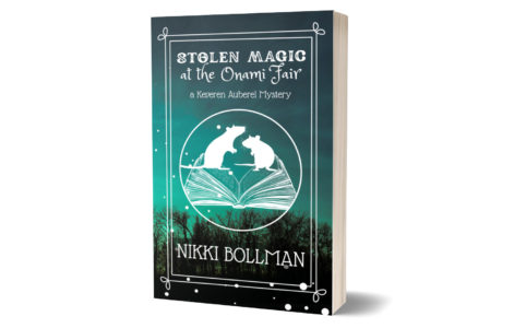 3D mockup of paperback of my book Stolen Magic at the Onami Fair. Cover features silhouettes of two rats standing above an open book against a teal sunset picture of a forest.